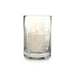 A lit white pillar candle inside a clear glass votive holder with a subtle frosted winter tree design, set against a plain white background.