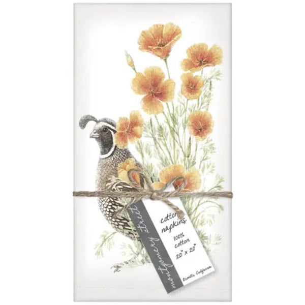A folded white cotton napkin featuring a printed illustration of a quail and orange wildflowers, wrapped with twine and a paper tag that reads 'cotton napkin 100% cotton 20 x 20' and 'Handmade in Texas.'.
