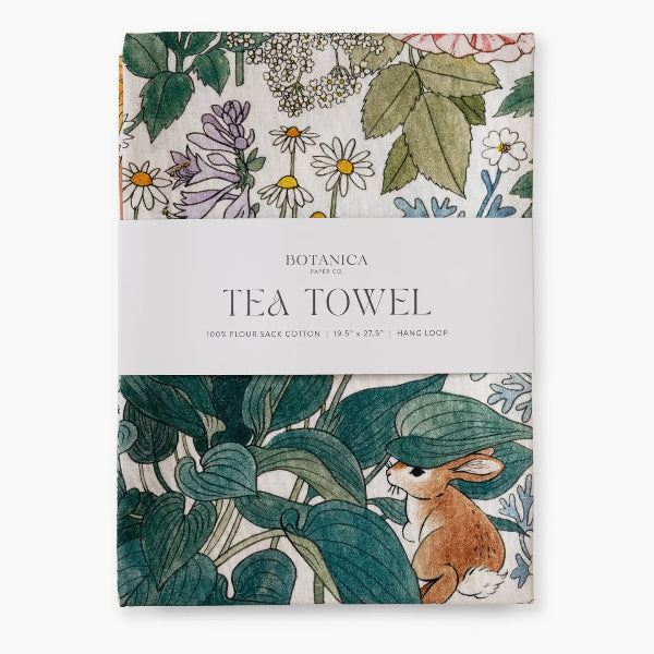 Tea towel packaging with floral and leaf design, featuring a rabbit illustration.