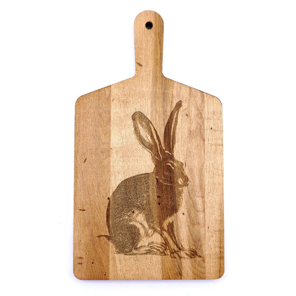 Wooden cutting board with a rabbit engraving on a white background