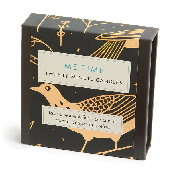 Box of 'Me Time' twenty-minute candles with a gold bird design on a black background.