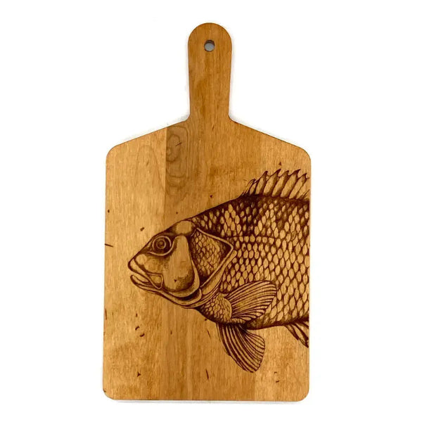 Wooden cutting board with a fish engraving on a white background