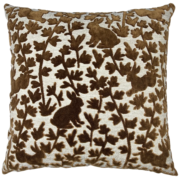 Decorative pillow with brown floral and rabbit pattern on a white background