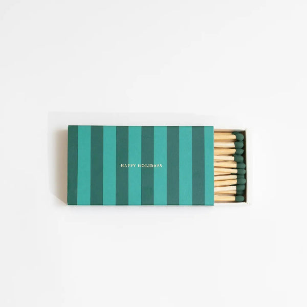 Matchbox with green striped lid and wooden matches on a white background