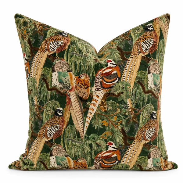 A srectangular decorative throw pillow featuring a detailed print of pheasants and birds amidst green foliage, set against a clean white background.
