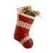 Red woven Christmas stocking with a beige bow and greenery on a white background