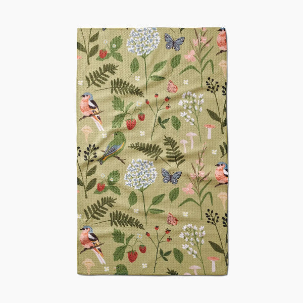 Floral and bird patterned towel on a white background