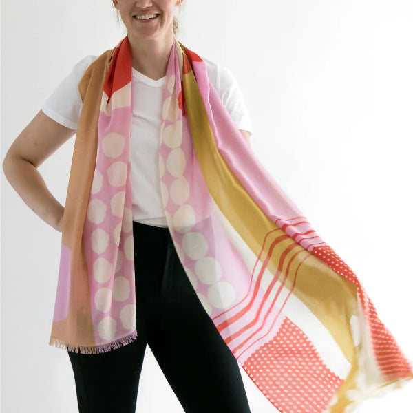 Person wearing a colorful scarf with a white background