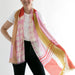 Person wearing a colorful scarf with a white background