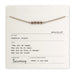 Bracelet on a card with text and branding details