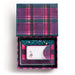 An open gift box with a purple, pink, and green plaid patterned lid and interior, containing a small white card with a bunny illustration and a matching curved insert.
