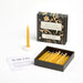 Yellow candles in a box with a decorative box labeled 'With Love Twenty Minute Candles' on a white background.