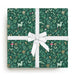 Gift wrap with forest pattern and white ribbon on a white background