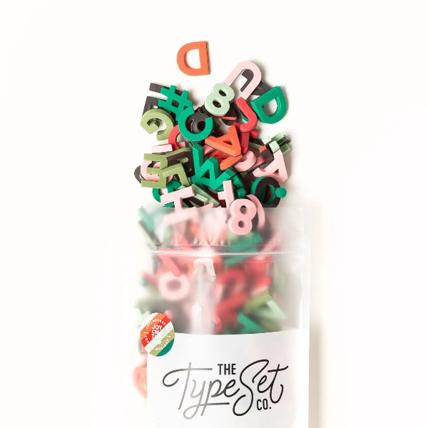 Colorful letter and number magnets in a clear plastic bag with 'The Type Set Co.' branding.