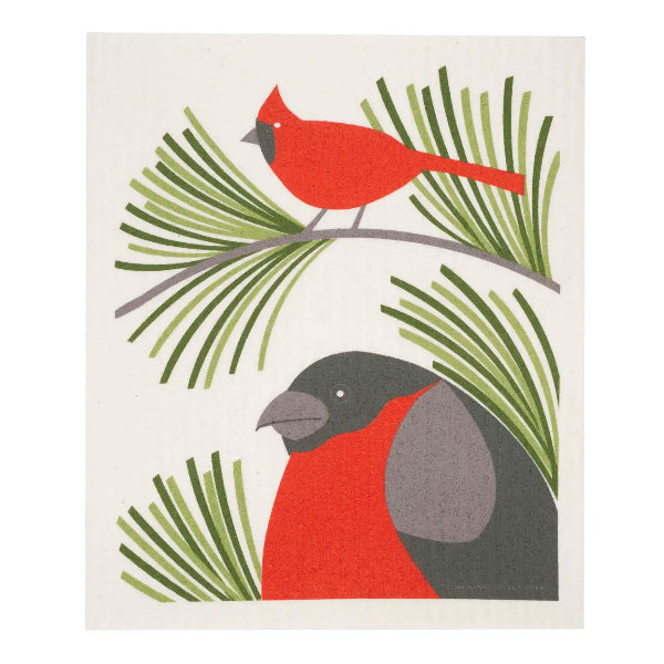 A minimalist dishcloth featuring two birds on a cream background: a red cardinal perched on a branch at the top and a red-breasted bird in profile at the bottom, surrounded by stylized green pine needles.