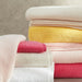 Stack of colorful towels on a neutral background