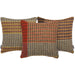 Three decorative throw pillows with intricate geometric and chevron woven patterns in red, orange, brown, and beige, arranged against a solid white background.