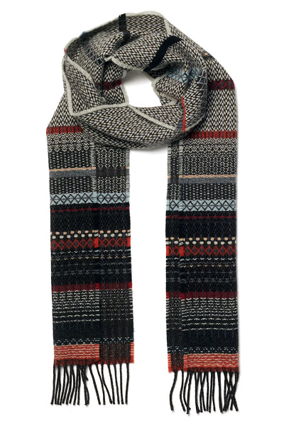 A patterned knit scarf with fringed ends, featuring horizontal bands of black, gray, beige, and rust red geometric and Fair Isle style motifs on a white background.