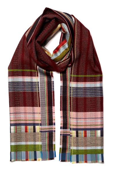 A multicolor plaid scarf with a dominant deep burgundy base, featuring stripes of green, navy, pink, beige, and white, arranged in a loop on a white background.