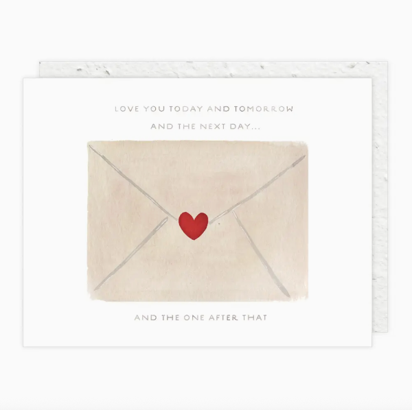Card with a beige envelope featuring a red heart and text on a white background