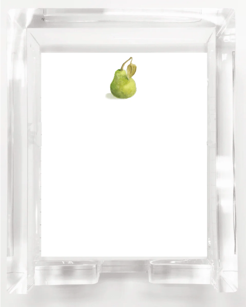 Green pear inside a clear glass container on a white background