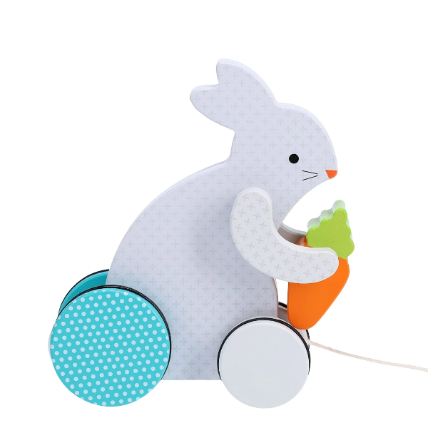White rabbit toy with wheels and a carrot on a white background