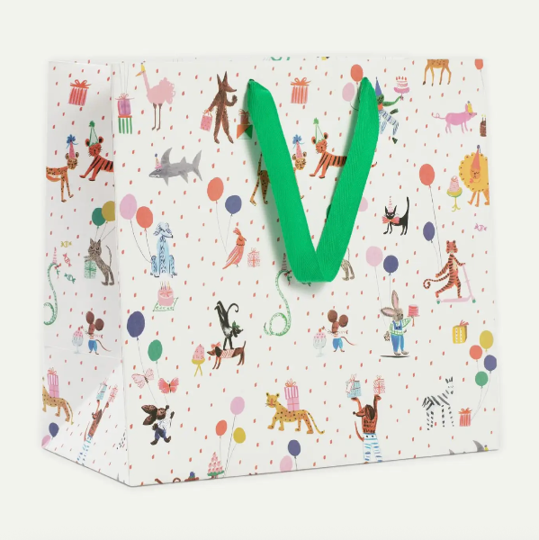 Gift bag with colorful animal pattern and green letter 'V' on a white background