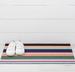Colorful striped doormat with white sneakers on a white wooden floor