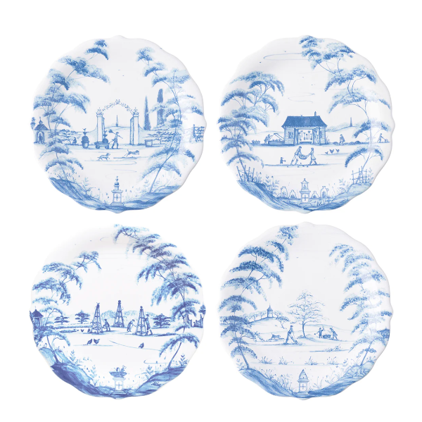 Four blue and white ceramic plates with scenic designs on a white background