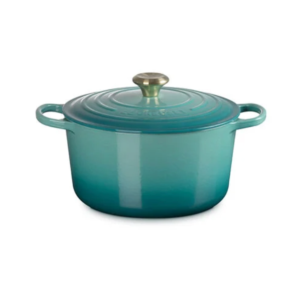 Turquoise enameled cast iron Dutch oven on a white background