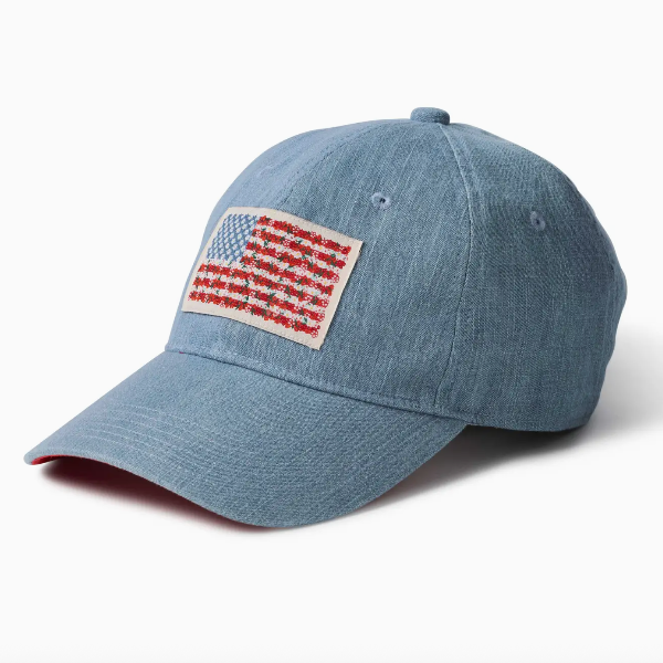 Blue denim cap with American flag patch on a white background