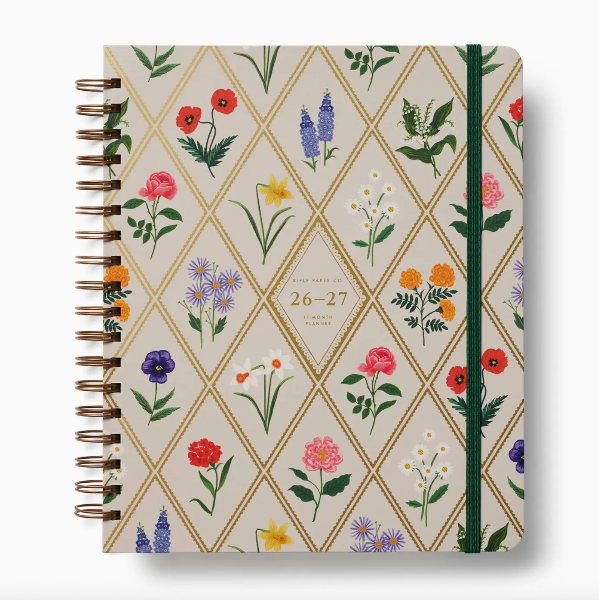 Notebook with floral pattern and gold accents on a white background
