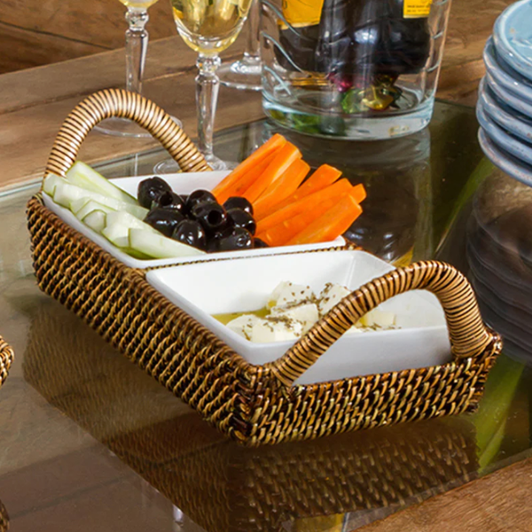Wicker basket with snacks on a glass table