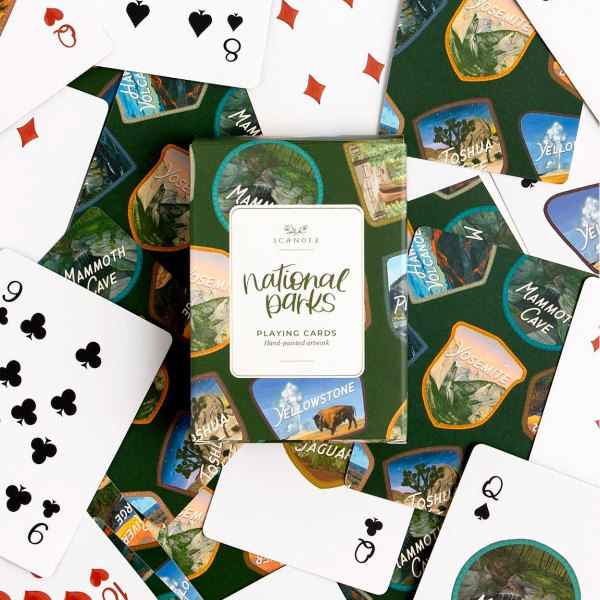 Playing cards with national park designs on a green background