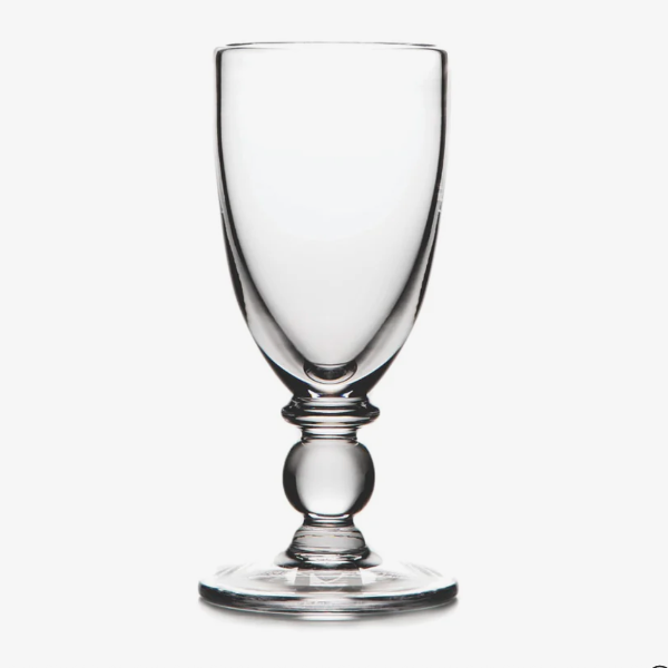 Clear glass goblet on a white background
