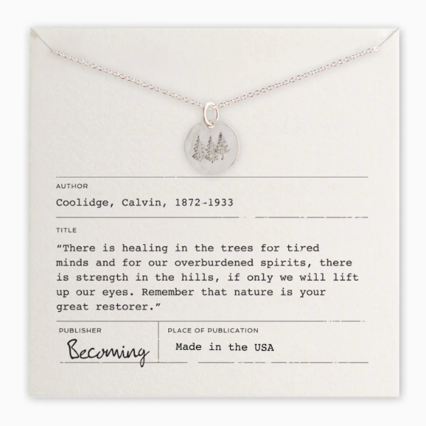 Necklace with a pendant on a card featuring text and branding