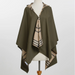 An olive green hooded poncho with a beige and black plaid pattern lining, displayed on a white mannequin torso against a light gray background.