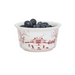 A white ceramic bowl with a red winter landscape print, filled with blueberries, on a solid white background.