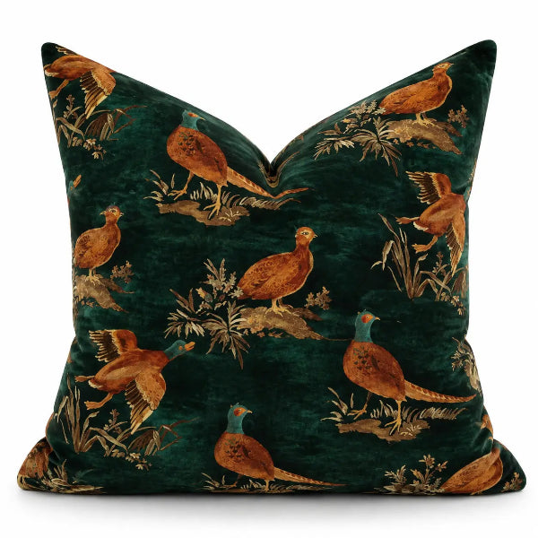 A rectangular throw pillow in dark green velvet with an all-over print of pheasant and duck birds in brown, gold, and teal, shown against a plain white background.