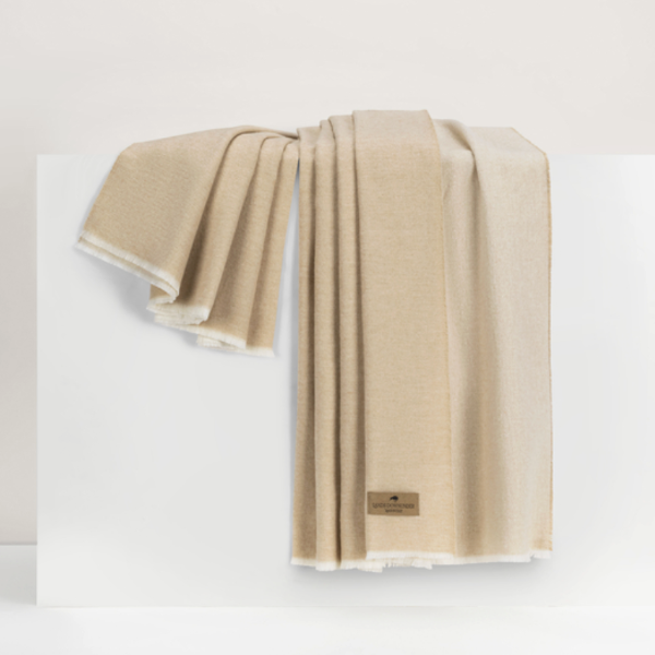 Beige towel with a brand logo on a white background