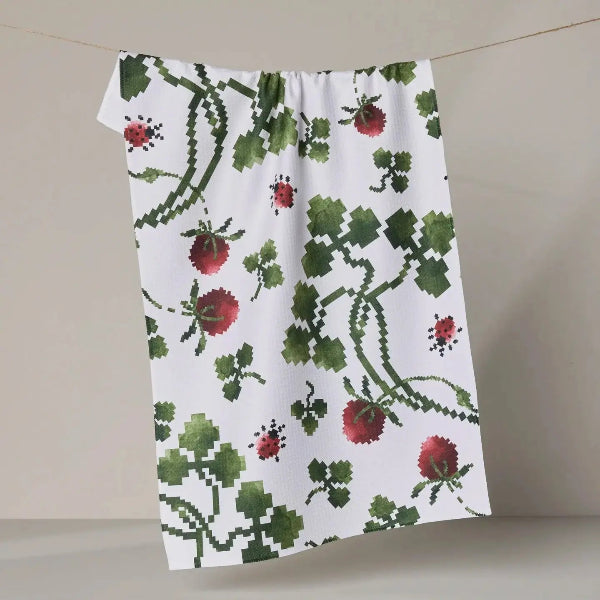 Floral patterned towel hanging on a line against a neutral background