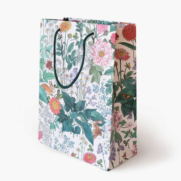 Floral and nature-themed gift bag on a white background