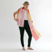 Woman holding a colorful scarf against a white background