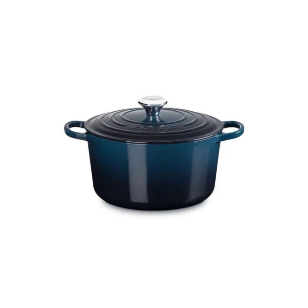 Blue enameled cast iron Dutch oven on a white background
