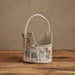 Fabric basket with printed design on a wooden surface and brown background