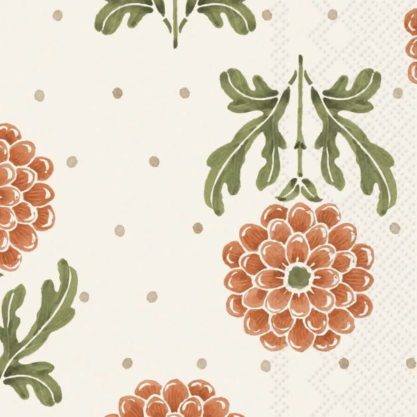 A close-up of a floral patterned surface featuring large rust-orange flowers, green leaves, and small taupe dots on a warm off-white background.