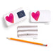 Notebook with heart design, pencil, and clear case on a white background