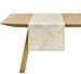 Wooden table with a floral patterned table runner on a white background