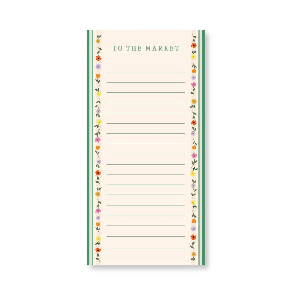 A vertical lined notepad with the words 'TO THE MARKET' at the top, bordered by green side panels and a decorative floral pattern in small multicolored flowers along the edges.