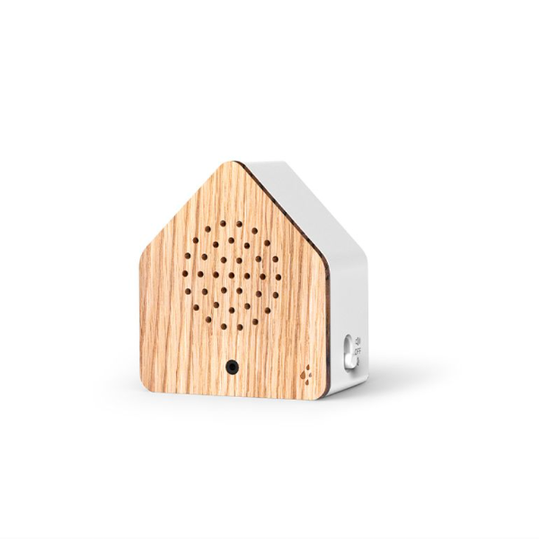 Small house-shaped device with wooden front and white sides on a white background
